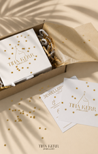 Tiha Kerr Jewellery packaging with branded cards and jewelry on a beige background