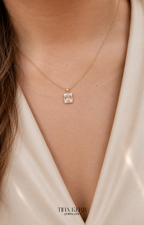 Gold necklace with a diamond pendant worn by a person in a white garment, branded 'Tina Kerr Jewellery'.